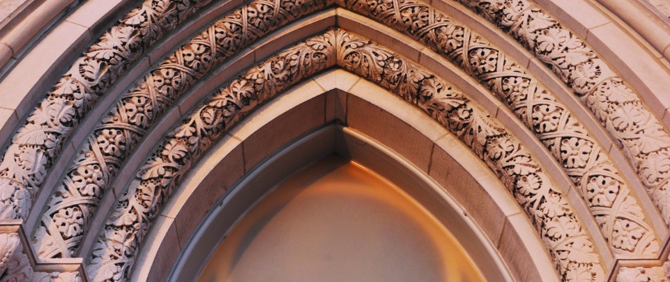 An up close view of intricately etched arches from the entrance of a church in Staunton Virginia.