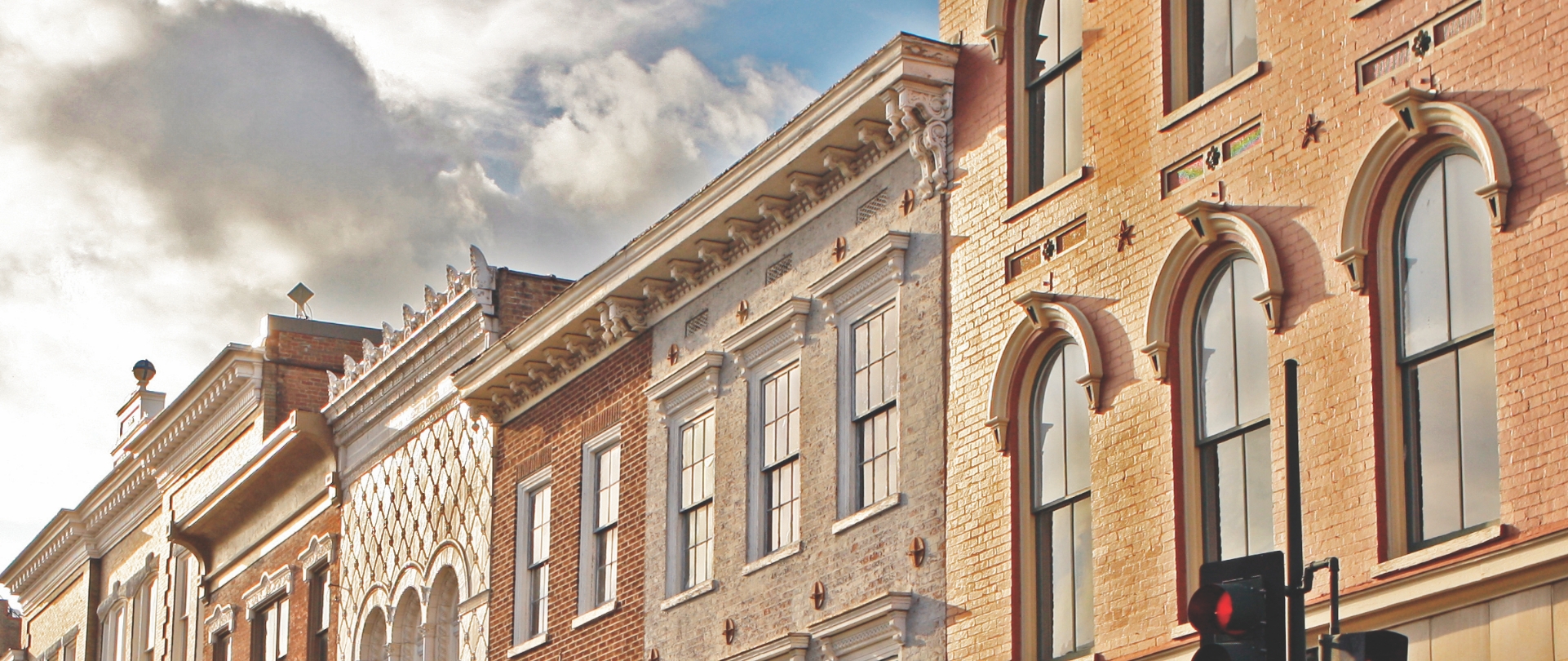 Brick facades of historical buildings in downtown Staunton Virginia line the street. 
